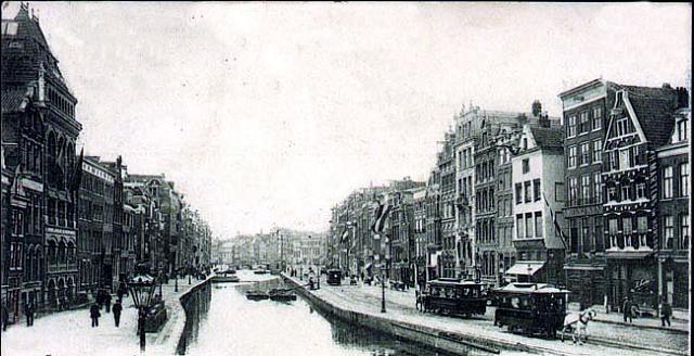 amsterdam rokin 31.  foto{1895)Nederlandsche Sigarenfabriek(eerste naam voor 1890)na 1890 Goulmy & BaarLinks :  fabriek Goulmy&Baar.Rechts:  Paardetram.Midden:  Het pontje.